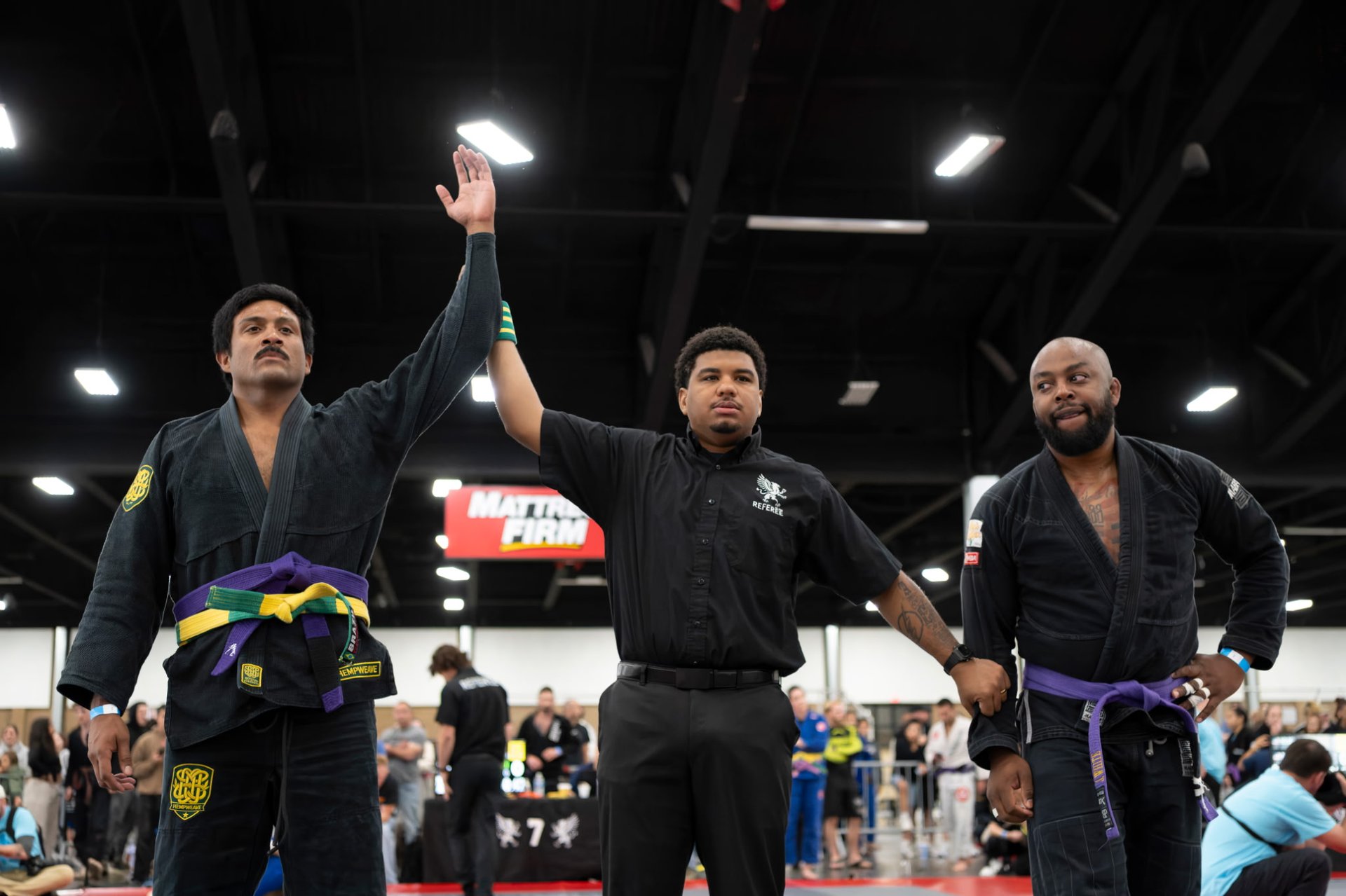 Referee raising the hand of a HempWeave athlete in victory