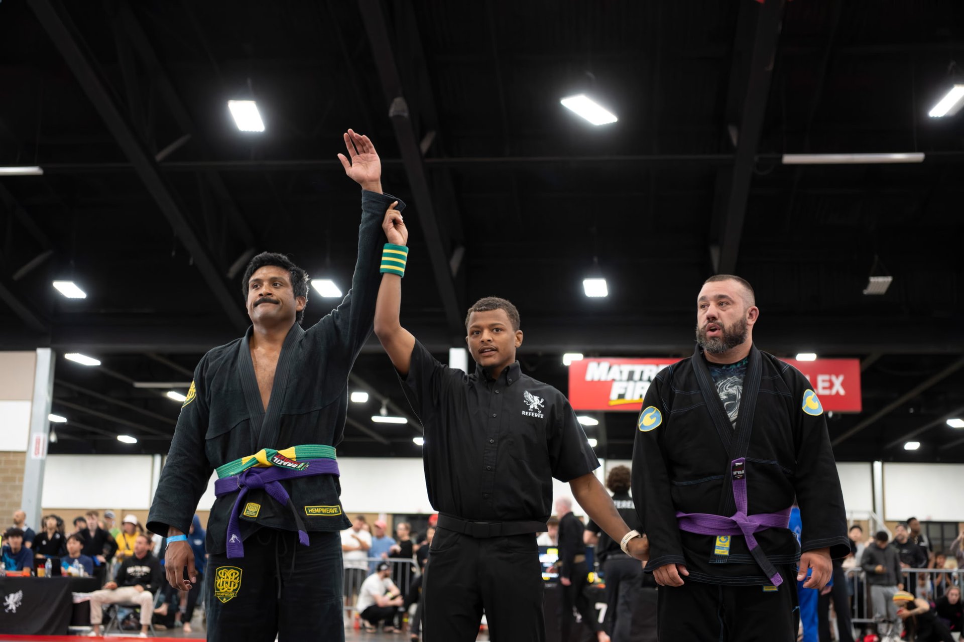 Referee raising the hand of a HempWeave athlete in victory